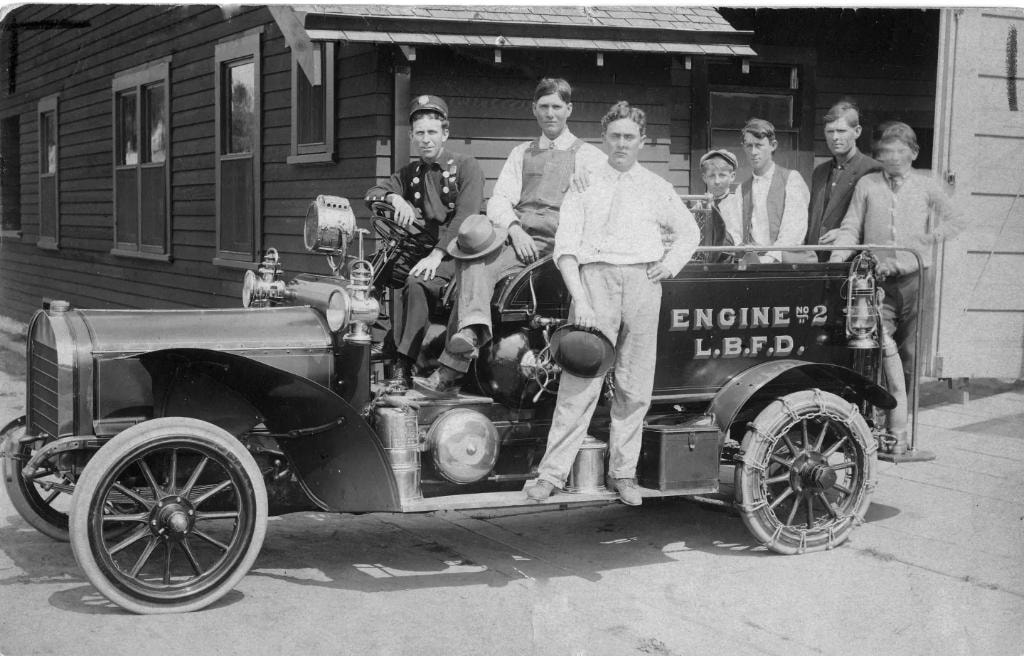 1907 Rambler Engine No. 2 L.B.F.D. with crew posing outside the firehouse