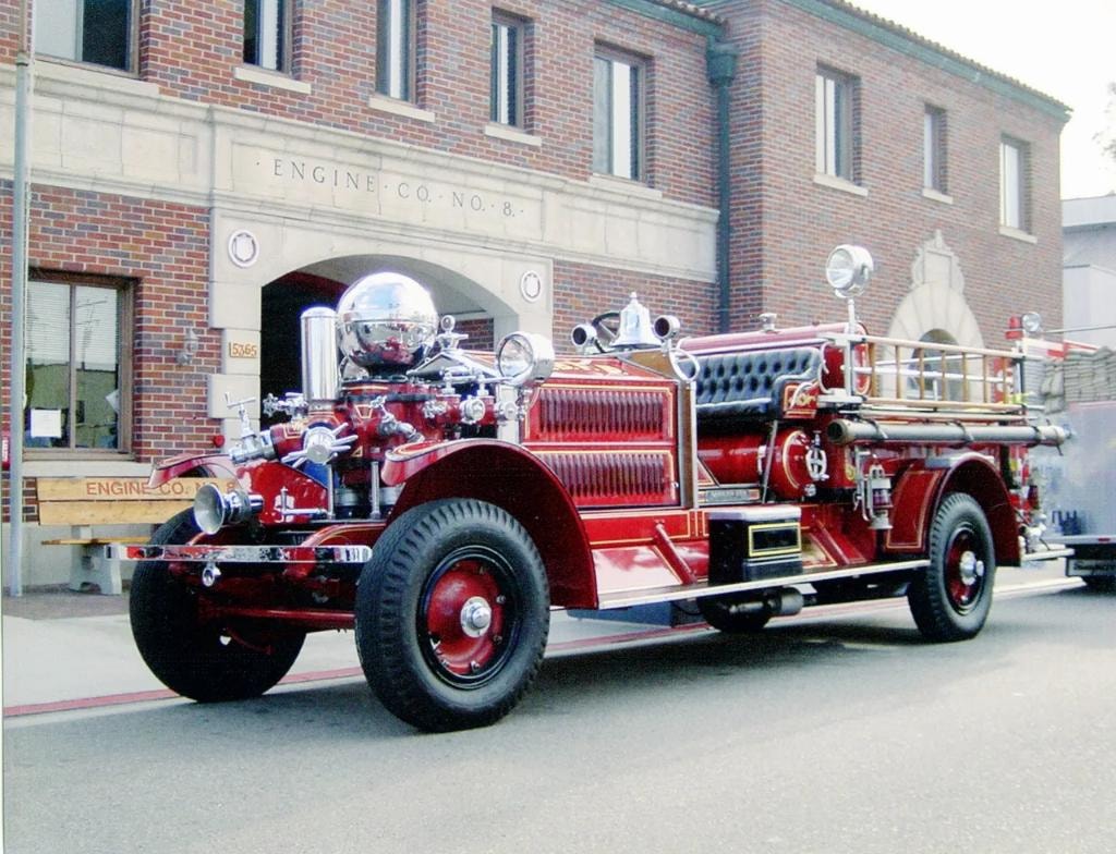 Vintage fire truck outside an engine company building